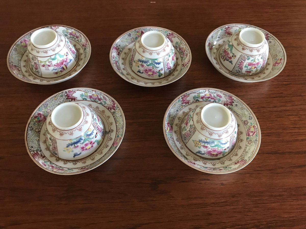 Five Samson Paris porcelain cups and saucers photographed on a wooden table